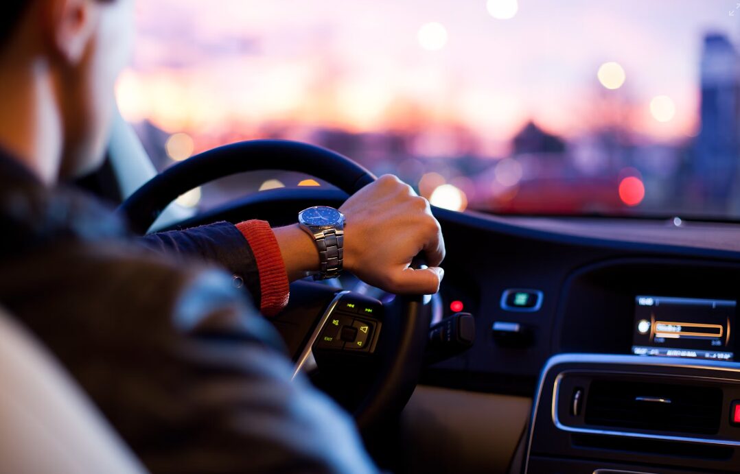 man driving on road